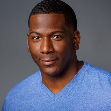 black male actor headshot blue t shirt